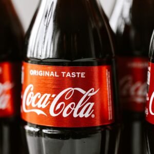 Close-up shot of Coca-Cola bottles highlighting the iconic red label and branding.